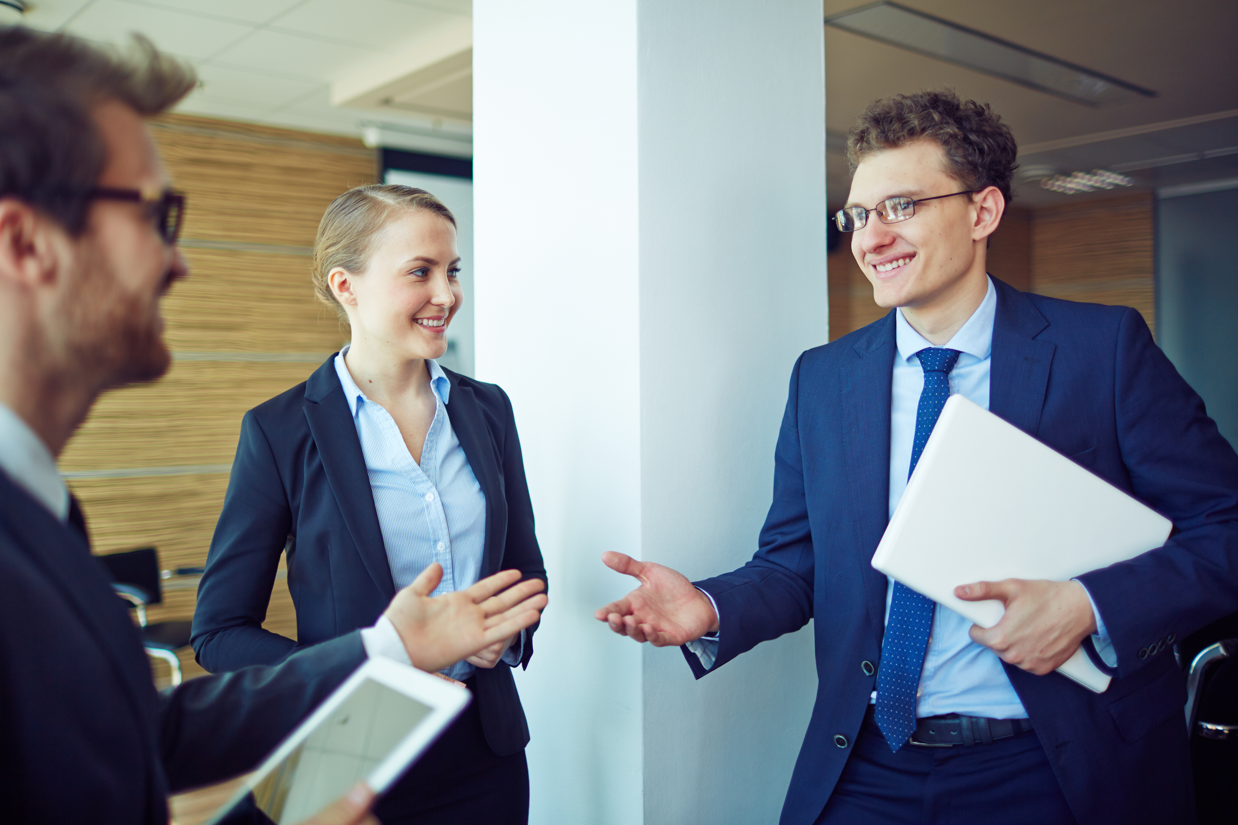 young-worker-smiling-with-his-workmates